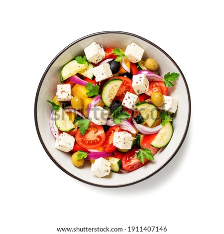 Classic Greek salad with fresh vegetables, feta cheese and  olives. Healthy food. isolated on white background. top view Royalty-Free Stock Photo #1911407146