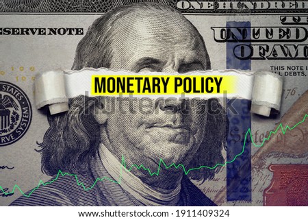 Torn bills revealing Monetary Policy words. Ideas for Increase or Decrease interest rates, Stimulate the economy, Moneyless valuable Royalty-Free Stock Photo #1911409324