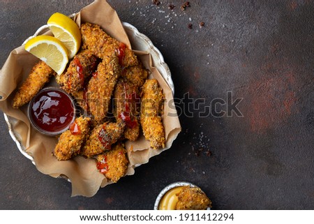 crispy fried Chicken strips with various dipping sauces Royalty-Free Stock Photo #1911412294