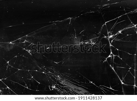 Fractured background. Broken glass texture. Black shattered aged faded window with dust scratches smeared stains abstract wallpaper.
