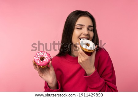 Photo of attractive lady holds donut candies sweet food wear casual pink sweater isolated pink color background