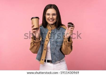 Photo of attractive lady holds coffee tea muffin happy cute sweet, wears casual jeans jacket white undershirt isolated pink color background