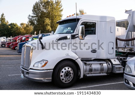 Resting place. Various types of trucks in the parking lot next to the motorway. Royalty-Free Stock Photo #1911434830