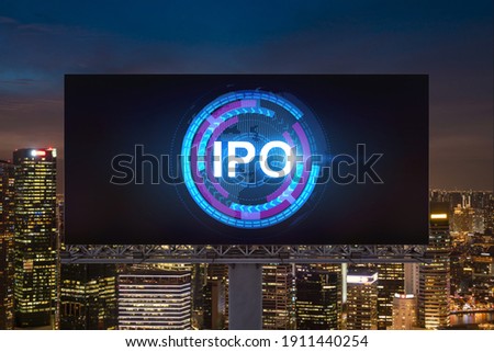 IPO icon hologram on road billboard over night panorama city view of Singapore. The hub of initial public offering in Southeast Asia. The concept of exceeding business opportunities.