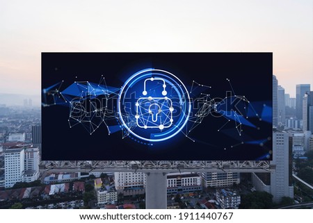 Padlock icon hologram on road billboard over panorama city view of Kuala Lumpur at sunset to protect business, Malaysia, Asia. The concept of information security shields.