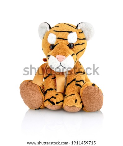 Tiger plushie doll isolated on white background with shadow reflection. Playful bright brown puppy toy. Plush stuffed puppet on white backdrop. Fluffy toy for children. Cute furry plaything for kids. Royalty-Free Stock Photo #1911459715