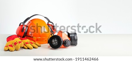 Personal protection equipment on gray surface with copy space. Job safety concept. Royalty-Free Stock Photo #1911462466