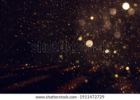 background of abstract gold and black glitter lights. defocused Royalty-Free Stock Photo #1911472729