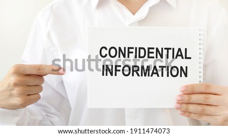 The girl points to a notebook with confidential information.