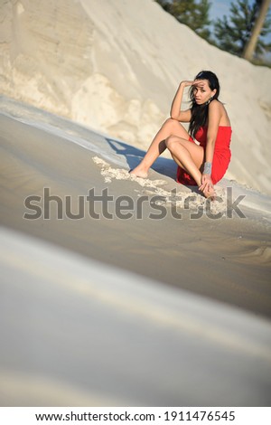 lifestyle photo of woman with perfect hair.walking alone at the beach.Sensual young girl relaxing.Colorful filter.glam style,teen trend outfit, positive mood,smiling,amazing model girl,long hair Royalty-Free Stock Photo #1911476545