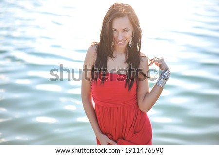 lifestyle photo of woman with perfect hair.walking alone at the beach.Sensual young girl relaxing.Colorful filter.glam style,teen trend outfit, positive mood,smiling,amazing model girl,long hair Royalty-Free Stock Photo #1911476590