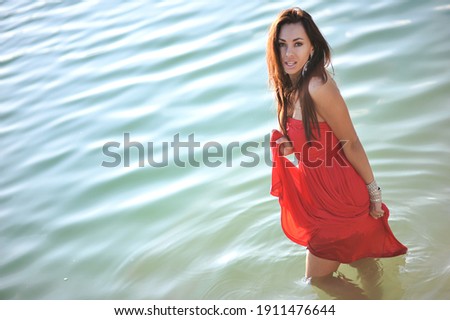 lifestyle photo of woman with perfect hair.walking alone at the beach.Sensual young girl relaxing.Colorful filter.glam style,teen trend outfit, positive mood,smiling,amazing model girl,long hair Royalty-Free Stock Photo #1911476644