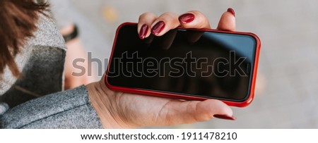 Reflection of a woman's face in the phone