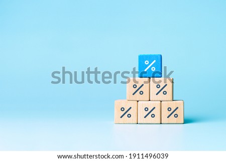 Wooden blocks with percentage sign, interest rate decline, investment reduce or Sales discount concept, copy space