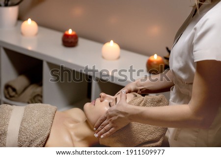 Relaxing massage. Woman receiving head massage at spa salon, side view. Royalty-Free Stock Photo #1911509977
