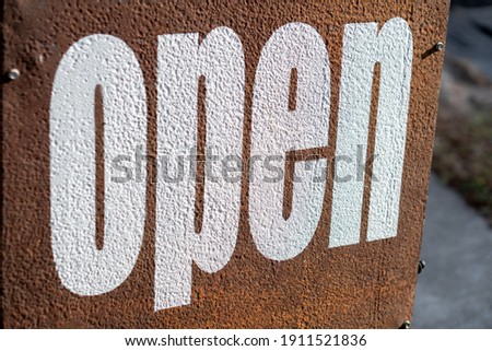 opened sign on the metal board 