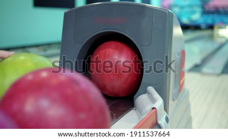 Bowling ball return system close-up. Girl takes a bowling ball 4k