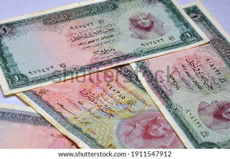 a defocused background for a collection of a blurred Egyptian one pound 1956 banknote and 1967 banknote. historic old Egyptian money