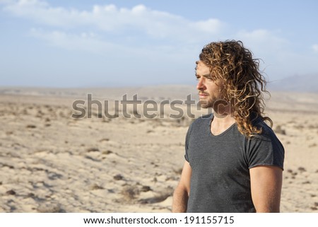 young man walking alone in the desert