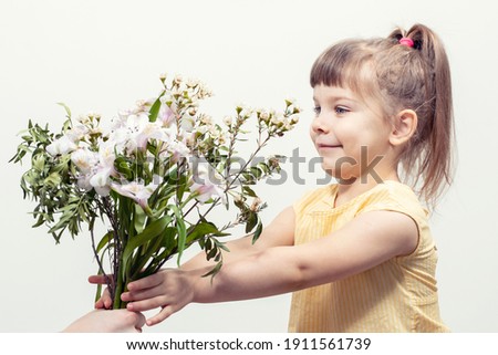 Congratulations. Photo of cute lovely little lady. hands hold bouquet give you present smile