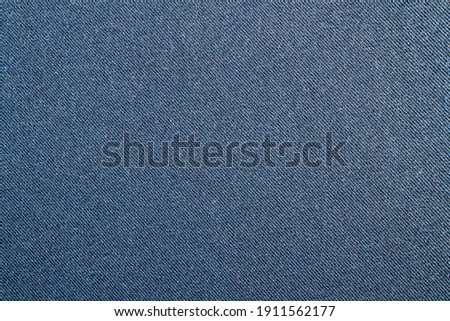 Dark blue tight denim background.Detailed texture of blue denim fabric with high resolution. Royalty-Free Stock Photo #1911562177