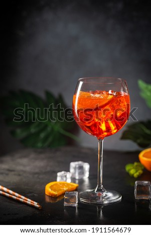 Aperol spritz cocktail in glass with fresh orange on dark background Royalty-Free Stock Photo #1911564679
