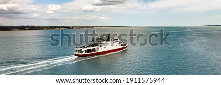 Banner - Car ferry in Southampton Water on a beautiful sunny day with clouds in the blue sky. Space for text. Royalty-Free Stock Photo #1911575944
