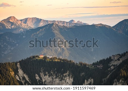 The summit station of Kreuzeck lit in the morning sun near mountain Zugspitze Royalty-Free Stock Photo #1911597469