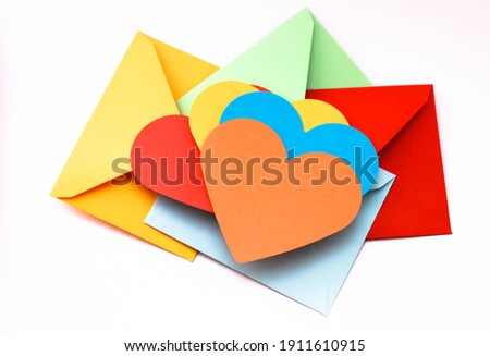 yellow, blue, red and orange heart craft paper and envelope for valentines day, for lgbt love, gay love, lesbian love.Top view, copy space for your text, concept photo 