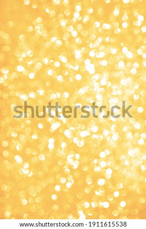Bokeh golden background. yellow  abstract bokeh snow falling winter christmas holiday background