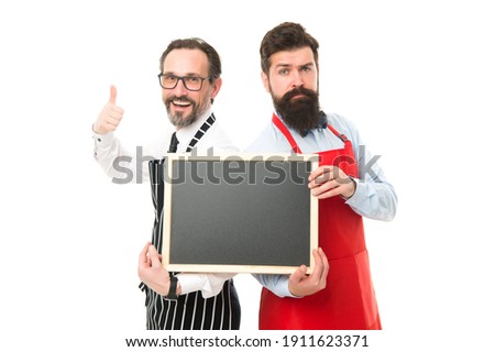 Time for healthy snack. menu planning. happy chef team in apron. partners celebrate start up. catering business. welcome on board. bearded men with blackboard, copy space. cafe and restaurant opening.