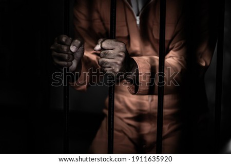 Asian man desperate at the iron prison,prisoner concept,thailand people,Hope to be free,Serious prisoners imprisoned in the prison Royalty-Free Stock Photo #1911635920