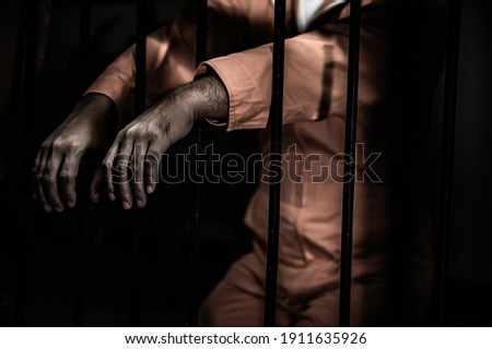 Asian man desperate at the iron prison,prisoner concept,thailand people,Hope to be free,Serious prisoners imprisoned in the prison Royalty-Free Stock Photo #1911635926