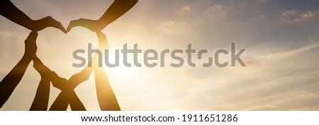 Symbol and shape of heart created from hands.The concept of unity, cooperation, partnership, teamwork and charity. Royalty-Free Stock Photo #1911651286