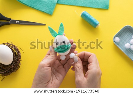 How to make felt bunny for Easter decor and fun.  DIY concept. Step by step photo instruction. Step 14. We glue the buboes to the bunny.