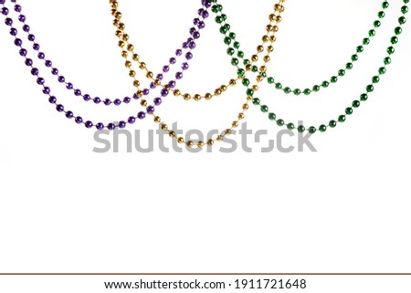 Three colour Merdi gras beads isolated on white background Royalty-Free Stock Photo #1911721648