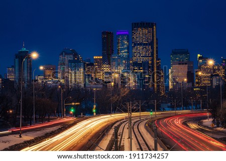 Light trails illuminating downtown Calgary roads at night Royalty-Free Stock Photo #1911734257