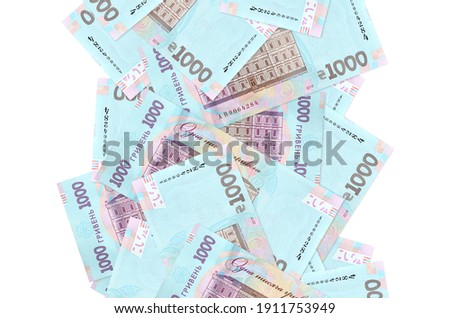 1000 Ukrainian hryvnias bills flying down isolated on white. Many banknotes falling with white copy space on left and right side