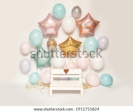 Photo zone on white background with colorful air gel balloons and wooden bench with heart for taking pictures of children, Birthday Part zone