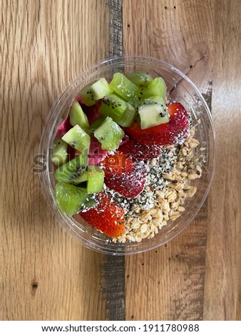 Dragon fruit base smoothie bowl with kiwi, strawberries and granola