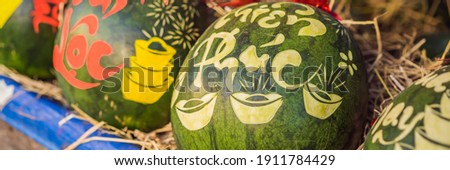BANNER, LONG FORMAT Water melons with festive engraving on Tet Eve. Tet is Lunar New Year and celebrated during four days in Vietnam TEXT TRANSLATION from Vietnamese: Congratulations on the Vietnamese