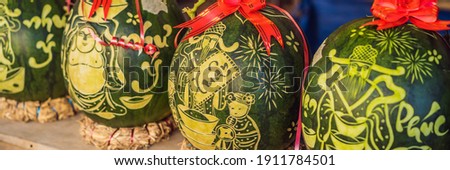 BANNER, LONG FORMAT Water melons with festive engraving on Tet Eve. Tet is Lunar New Year and celebrated during four days in Vietnam TEXT TRANSLATION from Vietnamese: Congratulations on the Vietnamese