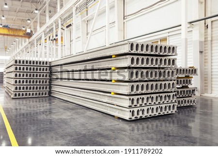 Stack of precast reinforced concrete slabs in a house-building factory workshop Royalty-Free Stock Photo #1911789202