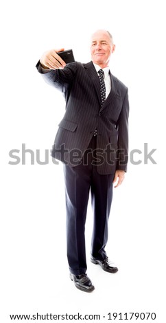Businessman photographing self with a mobile phone