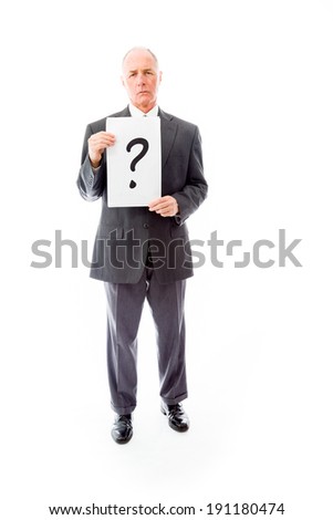 Businessman holding question mark sign
