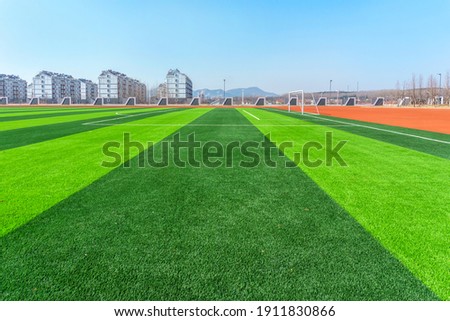 Football pitch and a cloudy sky. Green field. 