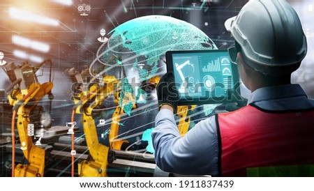 Smart industry robot arms modernization for digital factory technology . Concept of automation manufacturing process of Industry 4.0 or 4th industrial revolution and IOT software control operation . Royalty-Free Stock Photo #1911837439