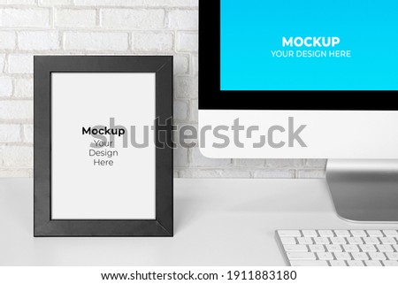 Mockup template monitor of computer display screen and picture frame with blank on desk, workplace and office, interior room, indoor, copy space, business and workspace concept.
