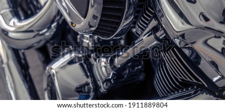 Selective focus on air filter of motorcycle. Shiny chrome motorbike engine detail. Closeup vintage motorbike parts. Motorcycle industry. 