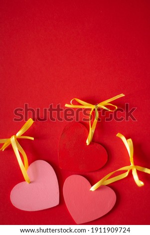 Red and pink hearts lie on a red background